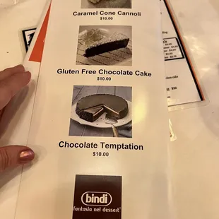 a hand holding a piece of cake