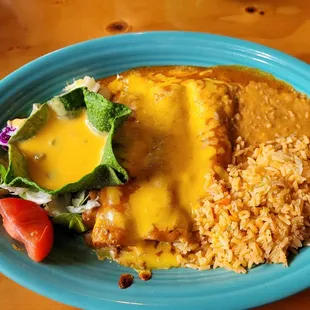 Beef enchiladas with beans,rice, and cheese puff.