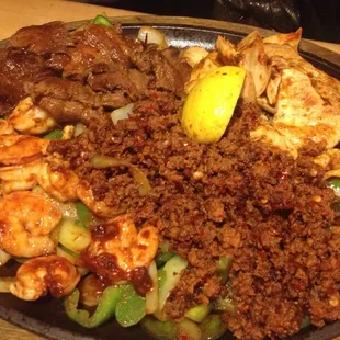 Cazuelada for two (shrimp, carne asada, chicken and chorizo with beans, rice, sour cream, guac and lettuce). 8 out of 10.
