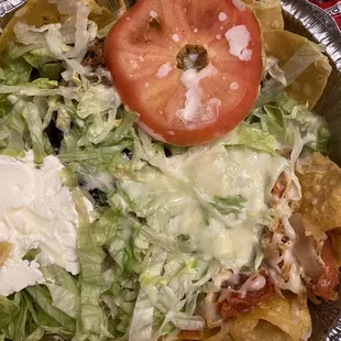 Patron nachos. No time to cut the stem out of  the tomato.  Soggy nachos.