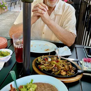 Shrimp fajitas with plenty of green and red peppers, onions, and mushrooms with homemade guacamole