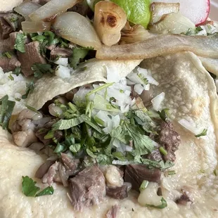 Lengua up front, cabeza to the left, and tripa on top right. Those grilled onions!