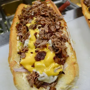 two sub sandwiches on a cutting board