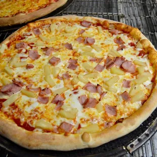 two pizzas on a grill