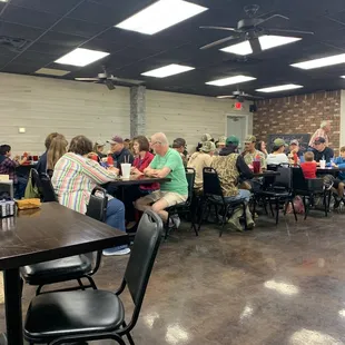 a large group of people sitting at tables