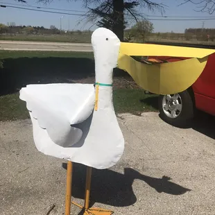 a duck with a boat in the background