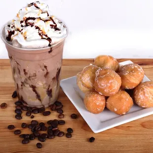 a cup of coffee and a plate of doughnuts