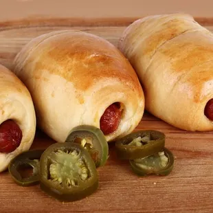 hot dogs wrapped in bread with cheese and jalapenos