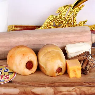 a rolling pin with hot dogs on it