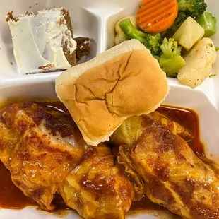 a plate of food with a sandwich and vegetables