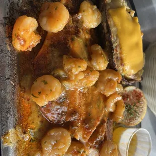Blackened redfish with shrimp étouffée and twice baked potato