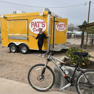 a woman standing next to a bike