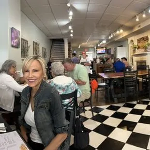 people sitting at tables in a restaurant