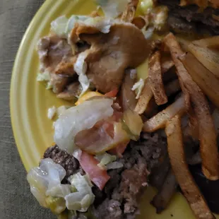 a hamburger and fries on a yellow plate