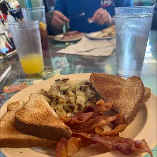 Toast, bacon, hash browns and mimosa...yeah my meal may be a bit basic but the flavor and this place is not.