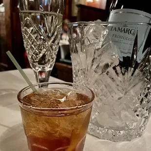 a glass of ice tea and a bottle of wine