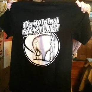 a man holding up a t - shirt