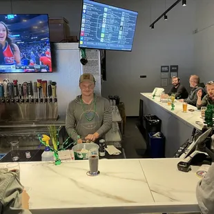 a group of people sitting at a bar