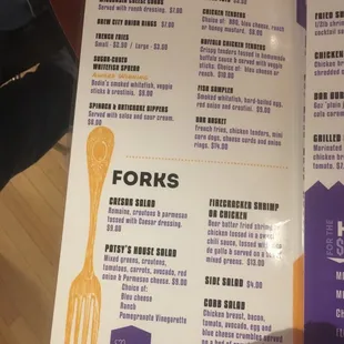 a hand holding a menu