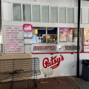 a storefront with a bench outside