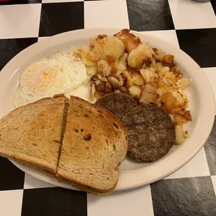 Breakfast, eggs sausage home fries and toast.