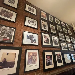 a wall full of framed photos
