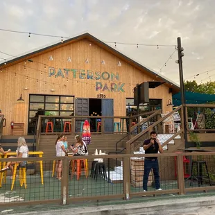 people sitting at tables outside a restaurant