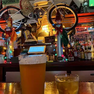 a glass of beer on a bar