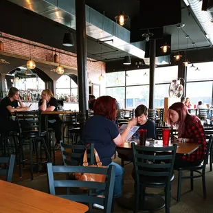 people sitting at tables in a restaurant