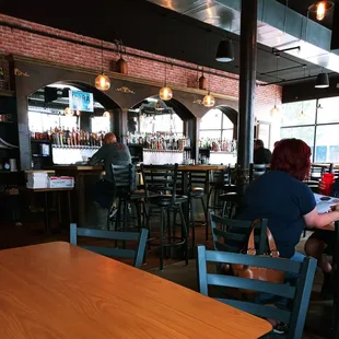 a woman sitting at a table in a restaurant