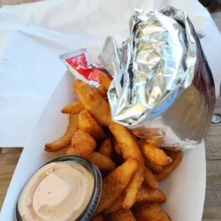a plate of french fries with a side of ketchup