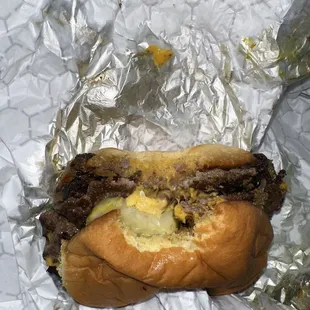 a hamburger with cheese and pickles