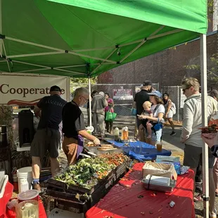 a group of people at a food stand