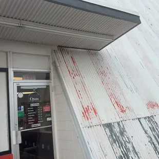 the exterior of a restaurant with a door open