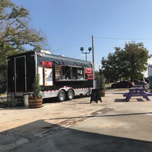 a woman walking past a food truck
