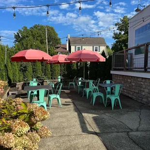 a patio with tables and umbrellas