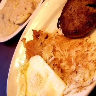 Sausage patty and eggs with biscuits and gravy.