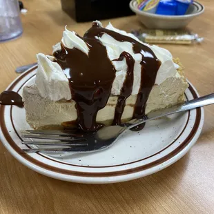 a slice of pie with chocolate sauce