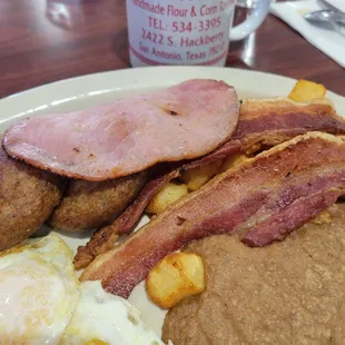 #17 Grande Ranchero Plate Two eggs, ham, two bacon strip, and two sausage patties. Served with beans &amp; potatoes.