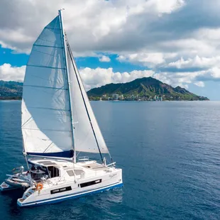 Pau Hana sailing off Waikiki Coast toward iconic Diamond Head.
