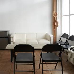 A cozy lounge area at Pauahi Street Photo Studio, perfect for relaxing between shoots in a bright, inviting space.