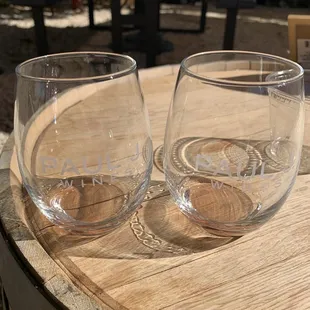 two wine glasses on a barrel