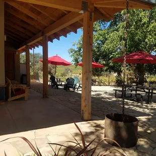 a patio with chairs and umbrellas