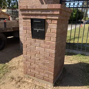 It's a very large brick mailbox surround with locking mailbox.