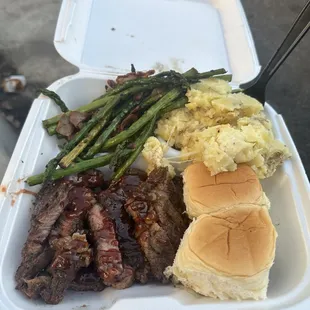 Ribeye, grilled asparagus, cheesy mashed potato&apos;s, and Hawaiian rolls