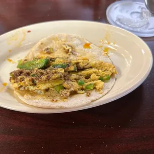 A delicious Chorizo con Huevo with chopped jalepenos on a Corn Tortilla