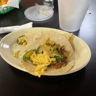 One El Rey breakfast taco and one Chorizo con huevo with chopped jalapeño breakfast taco