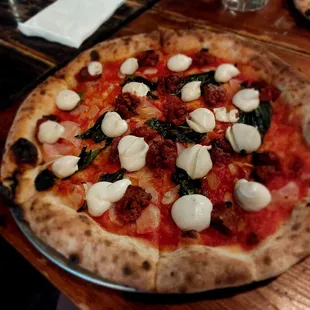 a pizza with mozzarella and spinach
