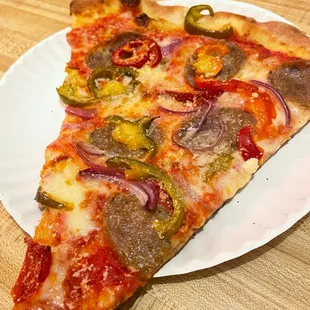a slice of pizza on a paper plate