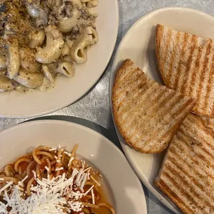 Small Canestri alla Funghi (top left), Small Bucatini Puttanesca (bottom right), and complimentary toast